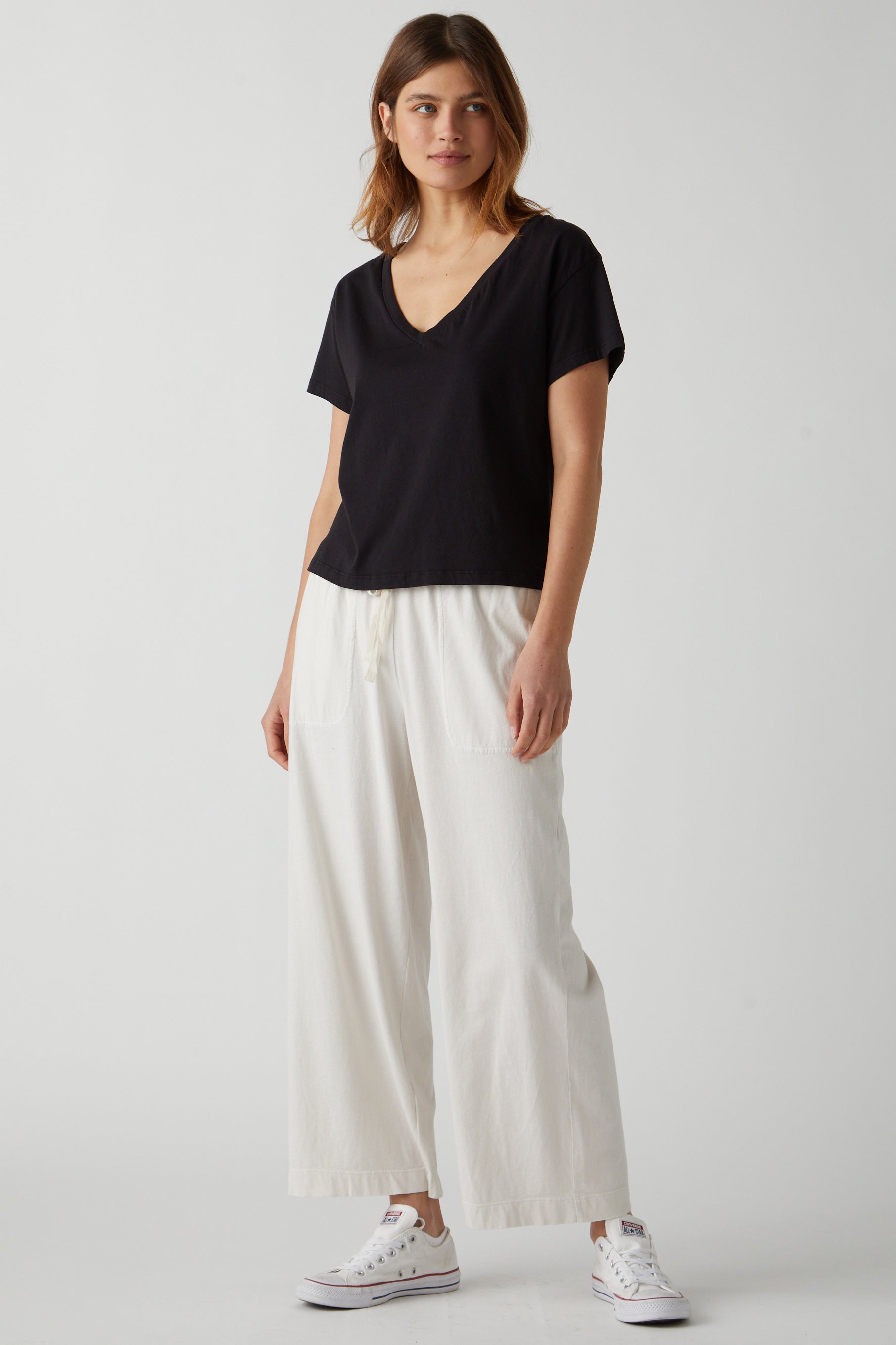   Pismo Pant in beach with Venice Tee in Black full length front 