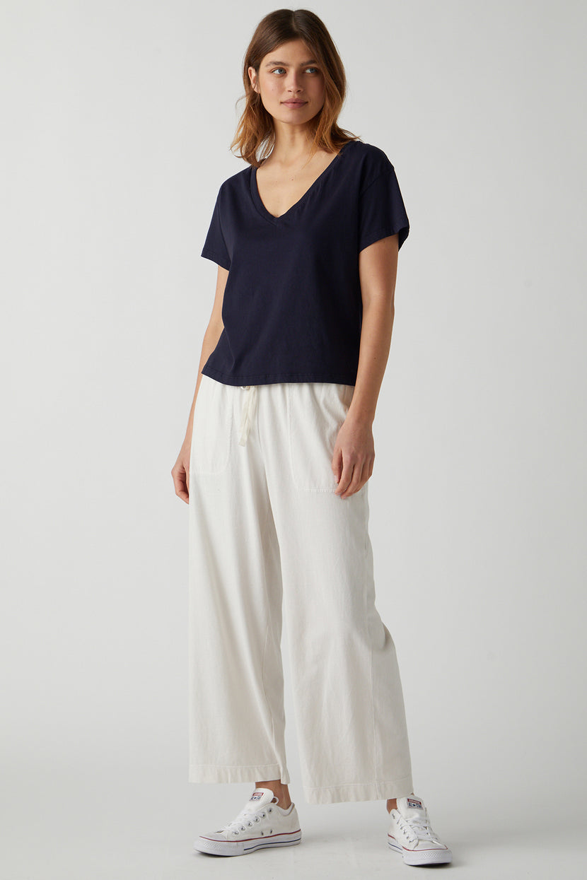 the model is wearing a Velvet by Jenny Graham VENICE TEE and wide leg pants.