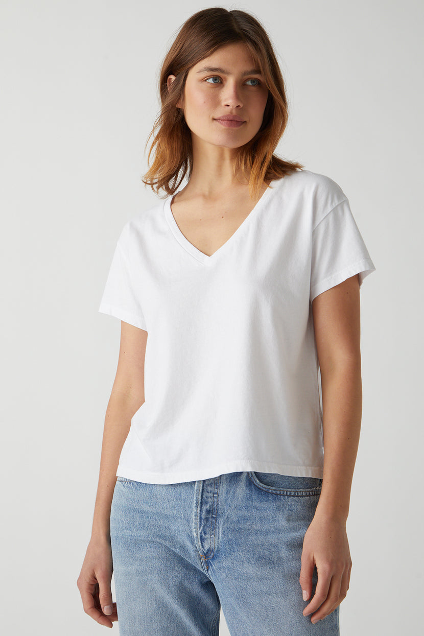 a woman wearing a white Velvet by Jenny Graham VENICE TEE and jeans.