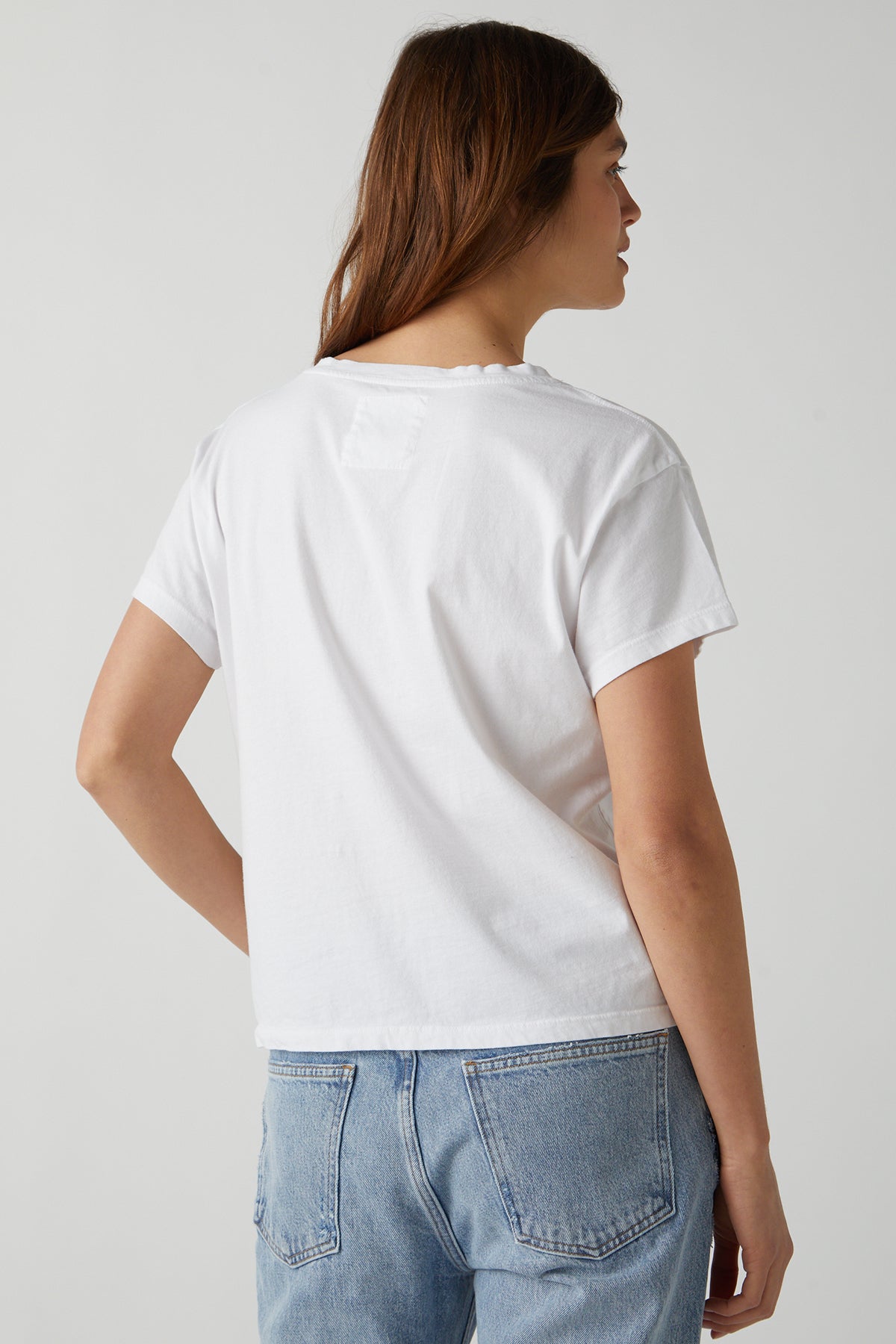 the back view of a woman wearing a Velvet by Jenny Graham VENICE TEE and jeans.-25484403048641