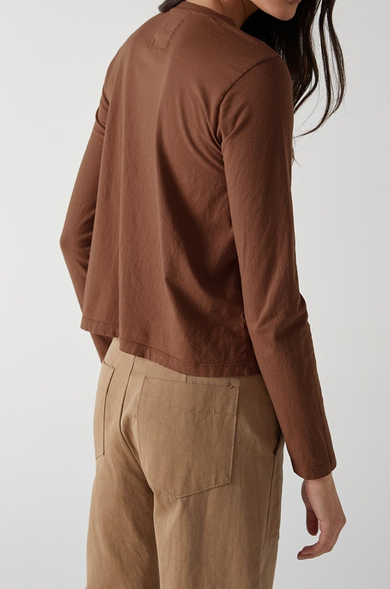 the back view of a woman wearing brown pants and a long - sleeved VICENTE TEE by Velvet by Jenny Graham.-24427647926465