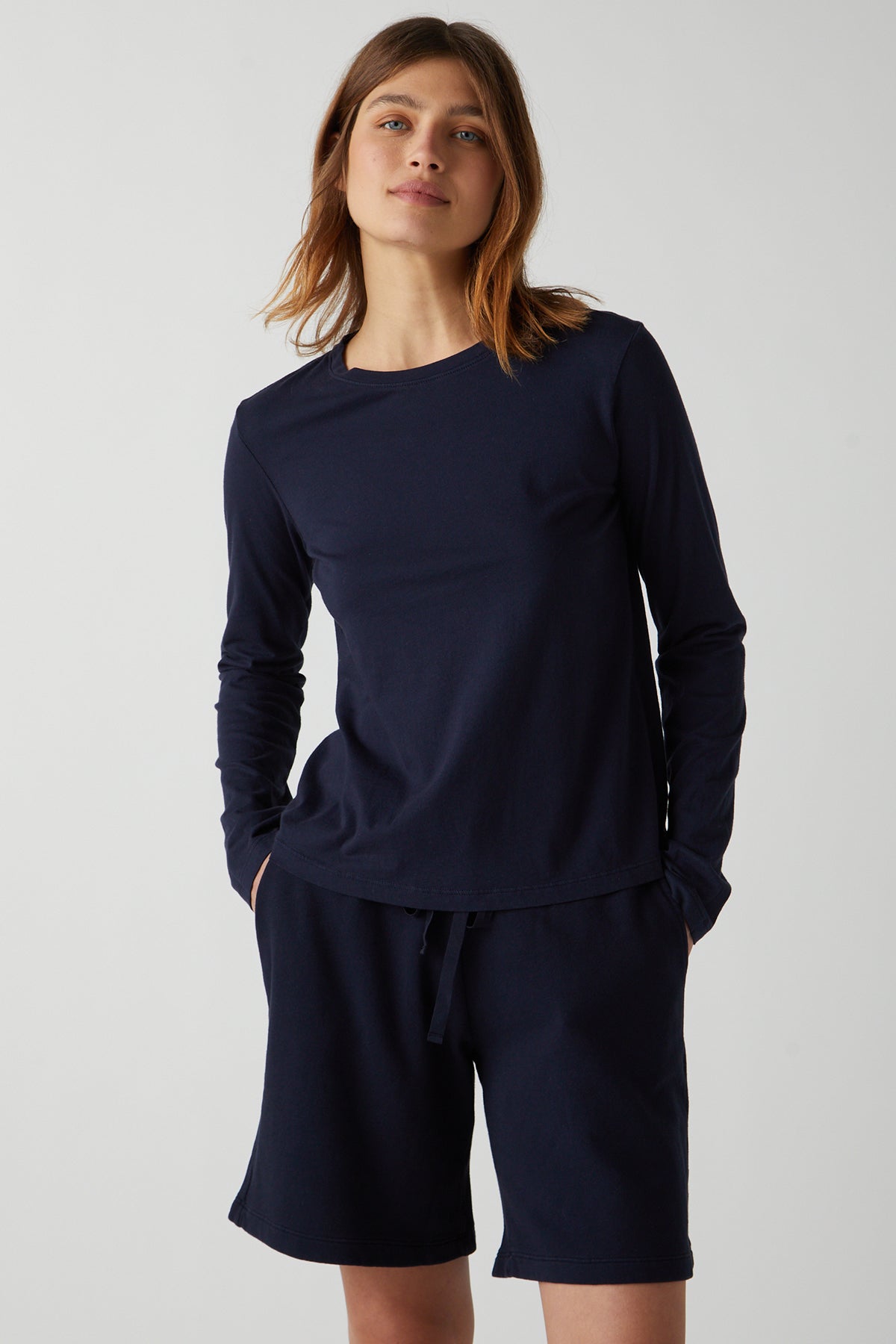   the model is wearing a navy long-sleeved top and Velvet by Jenny Graham LAGUNA SWEATSHORT. 