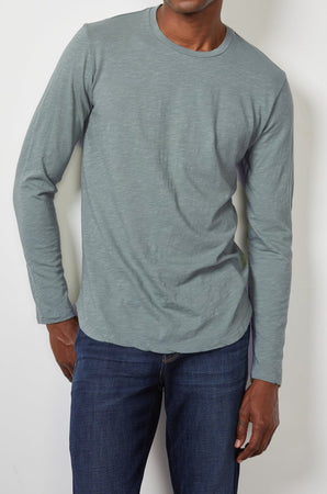 a man wearing jeans and a Velvet by Graham & Spencer CHANCE CREW NECK TEE.