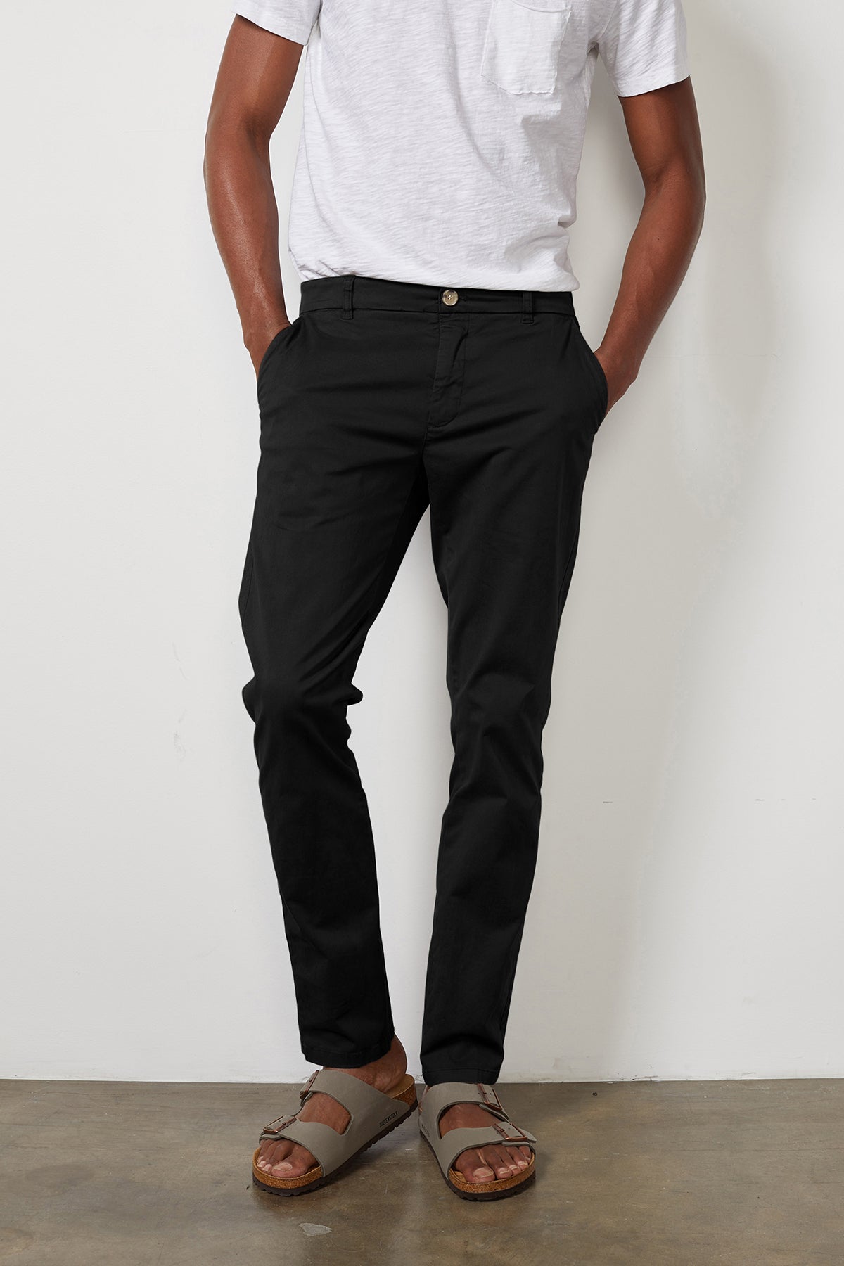   A man in a white t-shirt and the Velvet by Graham & Spencer BROGAN COTTON TWILL PANT with flawless fit. 