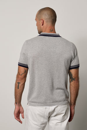 The back view of a man wearing a Velvet by Graham & Spencer FINLEY PIQUE POLO.
