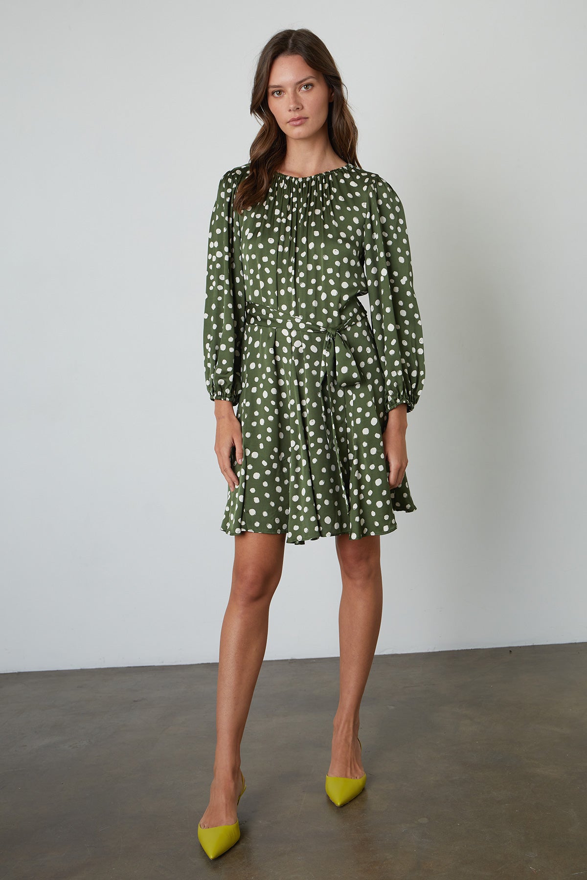 Kenia Polka Dot Dress with Green Background and Cream Dots Tied at Waist with heels full length view front-25078342090945