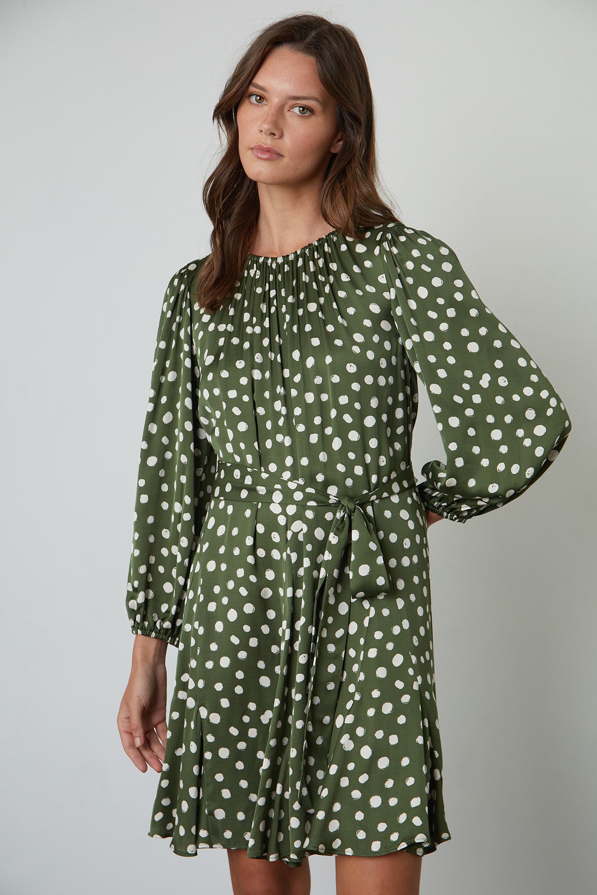   Kenia Polka Dot Dress with Green Background and Cream Dots Tied at Waist front 