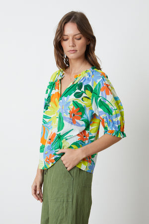 Carrie Boho Top in bold floral mahalo print with blues, greens, orange and yellow green and Dru Pant in basil side