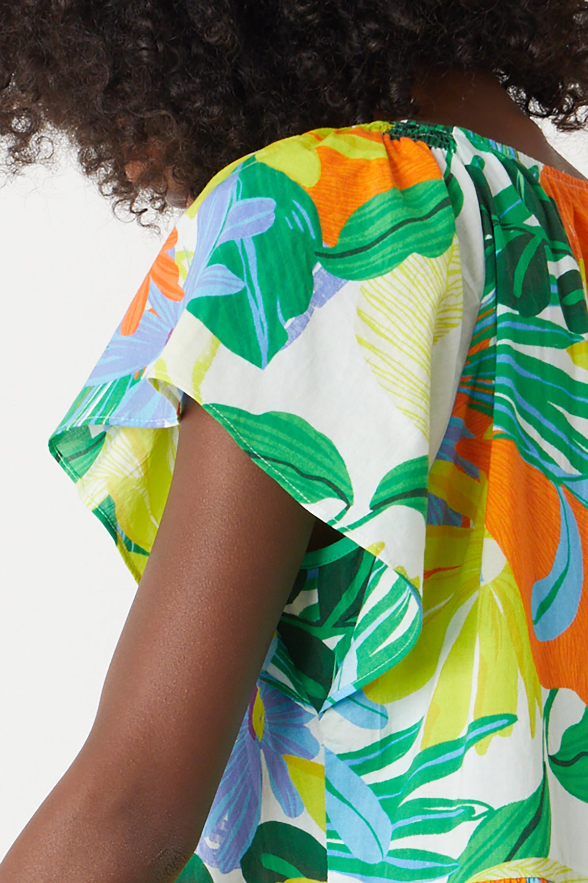   Maeve Tiered Dress in bold floral mahalo print with blues, greens, orange and yellow green close up side sleeve 