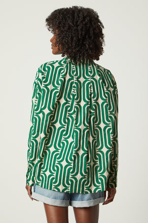the back view of a woman wearing a Velvet by Graham & Spencer ANNALISE PRINTED TOP shirt.