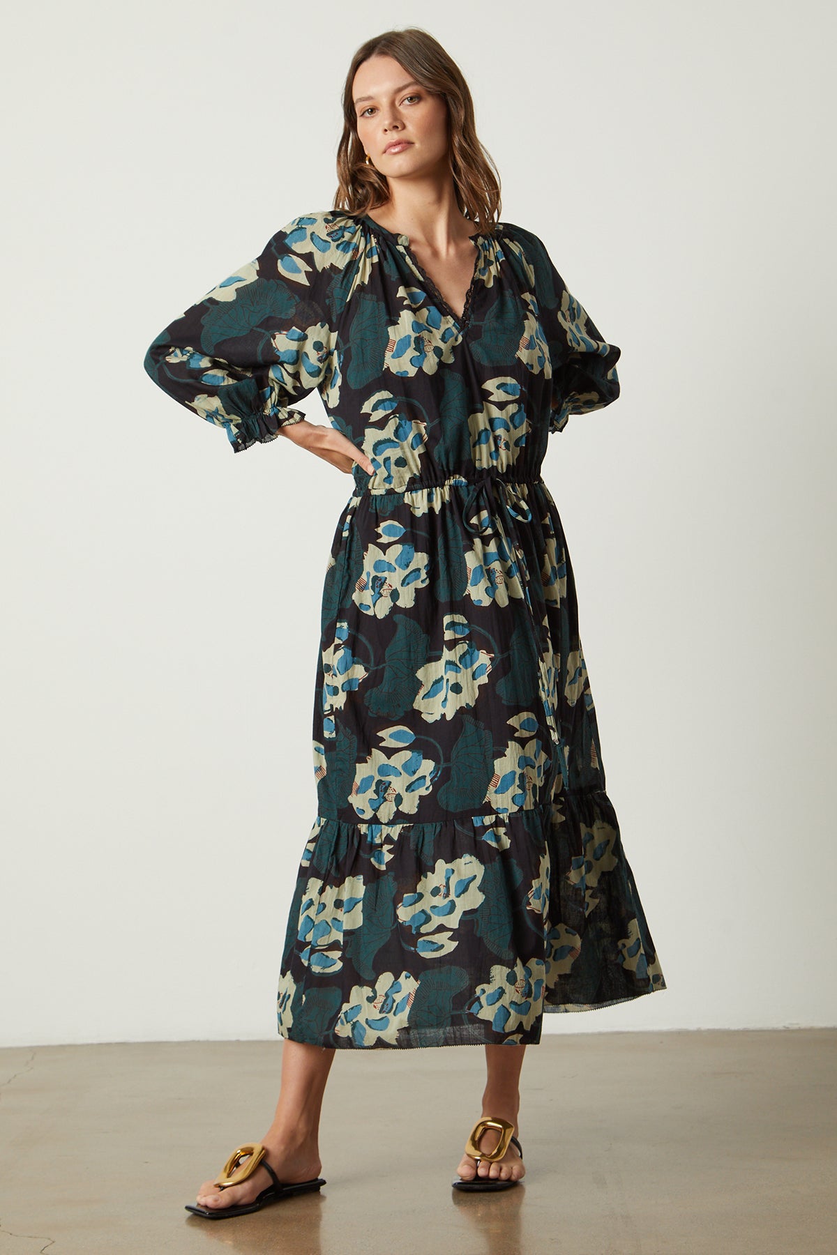 A woman wearing a Velvet by Graham & Spencer DENISE PRINTED COTTON LACE DRESS and sandals.-26022841614529