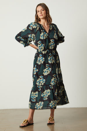 A woman wearing a Velvet by Graham & Spencer DENISE PRINTED COTTON LACE DRESS and sandals.