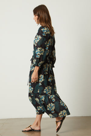 A woman is walking in a Velvet by Graham & Spencer DENISE PRINTED COTTON LACE DRESS.