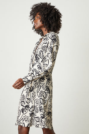 A woman wearing a Velvet by Graham & Spencer STEPHIE PRINTED CREPE DRESS.