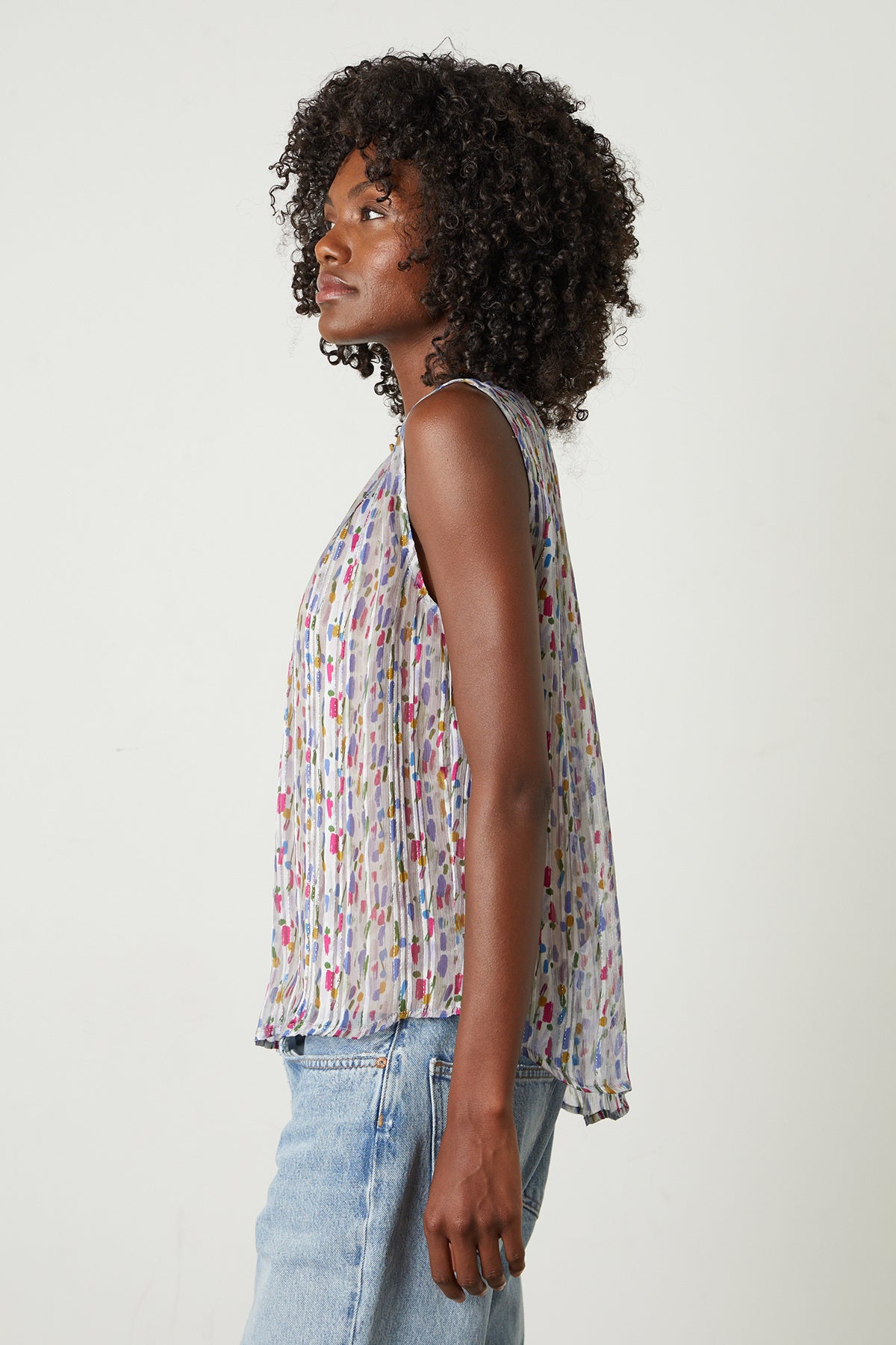 A woman wearing a Velvet by Graham & Spencer NADINE PRINTED LUREX STRIPE TANK TOP and jeans.-25870897283265
