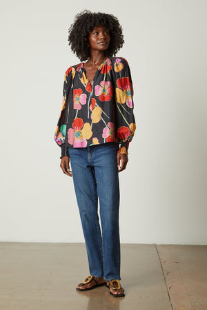 Avery Top in bold floral with black background and blue denim and sandals full length front