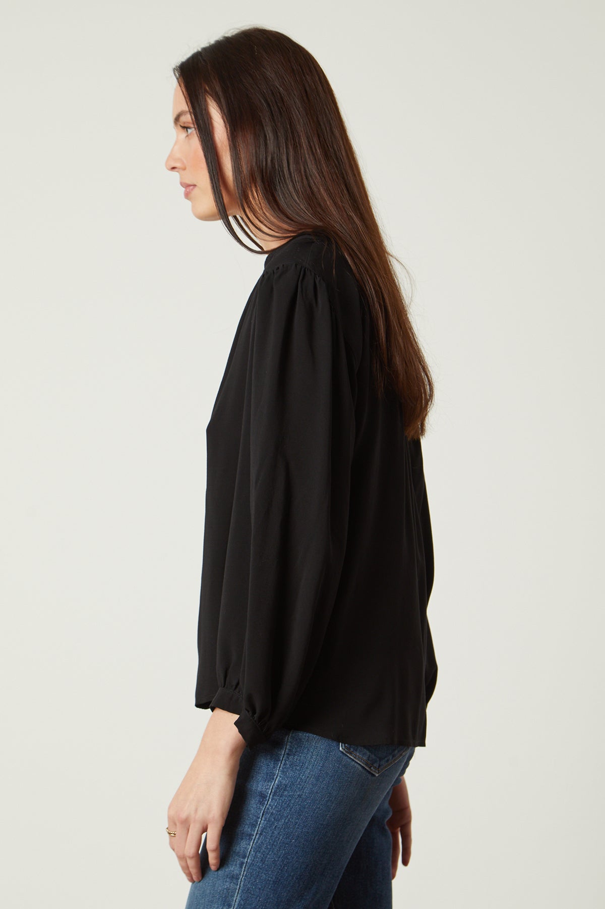   the back view of a woman wearing jeans and a Velvet by Graham & Spencer EMILY V-NECK BLOUSE. 