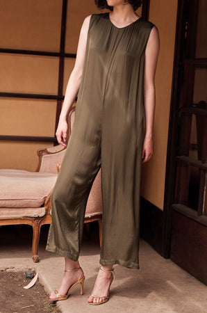A woman wearing a Velvet by Graham & Spencer IVY SATIN VISCOSE JUMPSUIT at a party.
