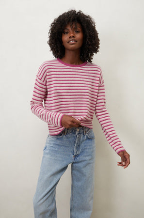 The model is wearing a Velvet by Graham & Spencer CADIE CASHMERE STRIPED SWEATER and jeans.
