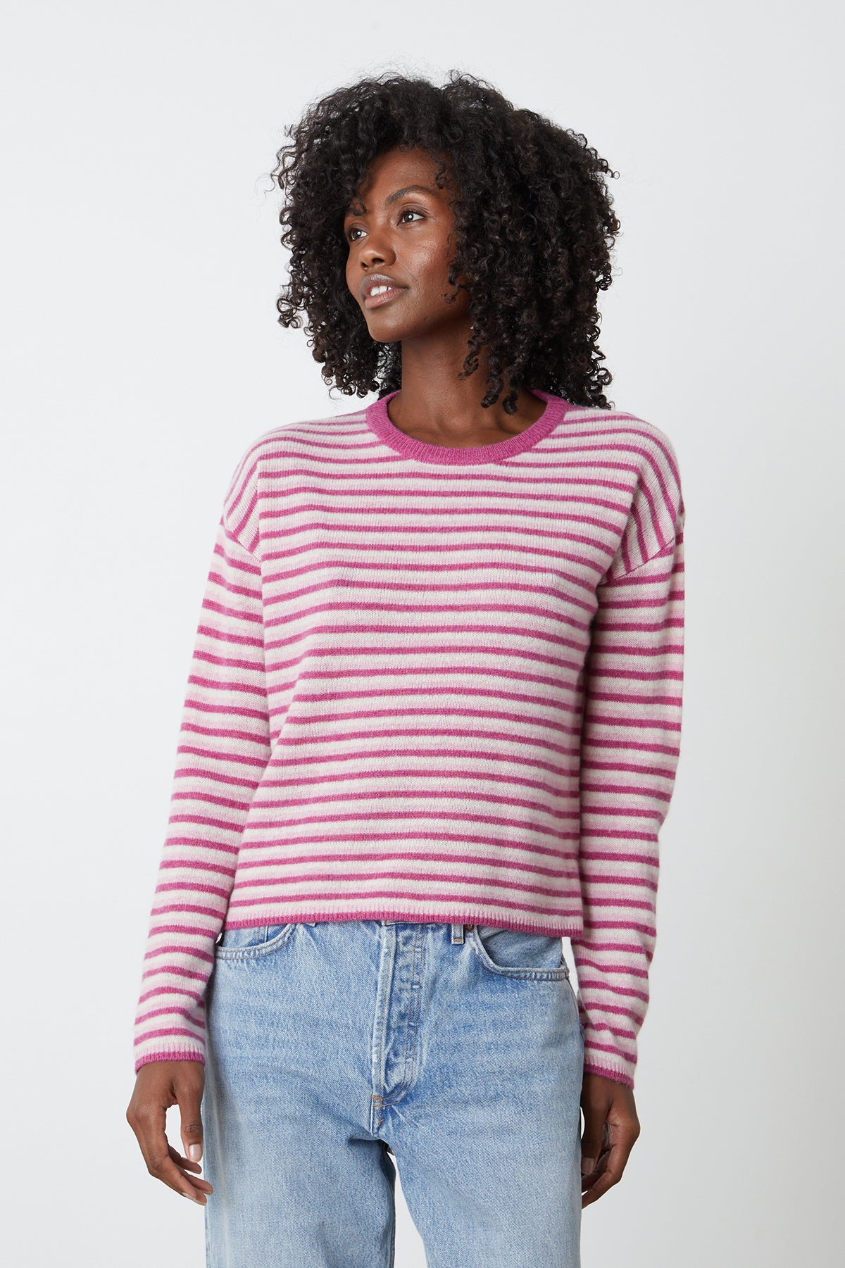   a model wearing CADIE CASHMERE STRIPED SWEATER by Velvet by Graham & Spencer and jeans. 