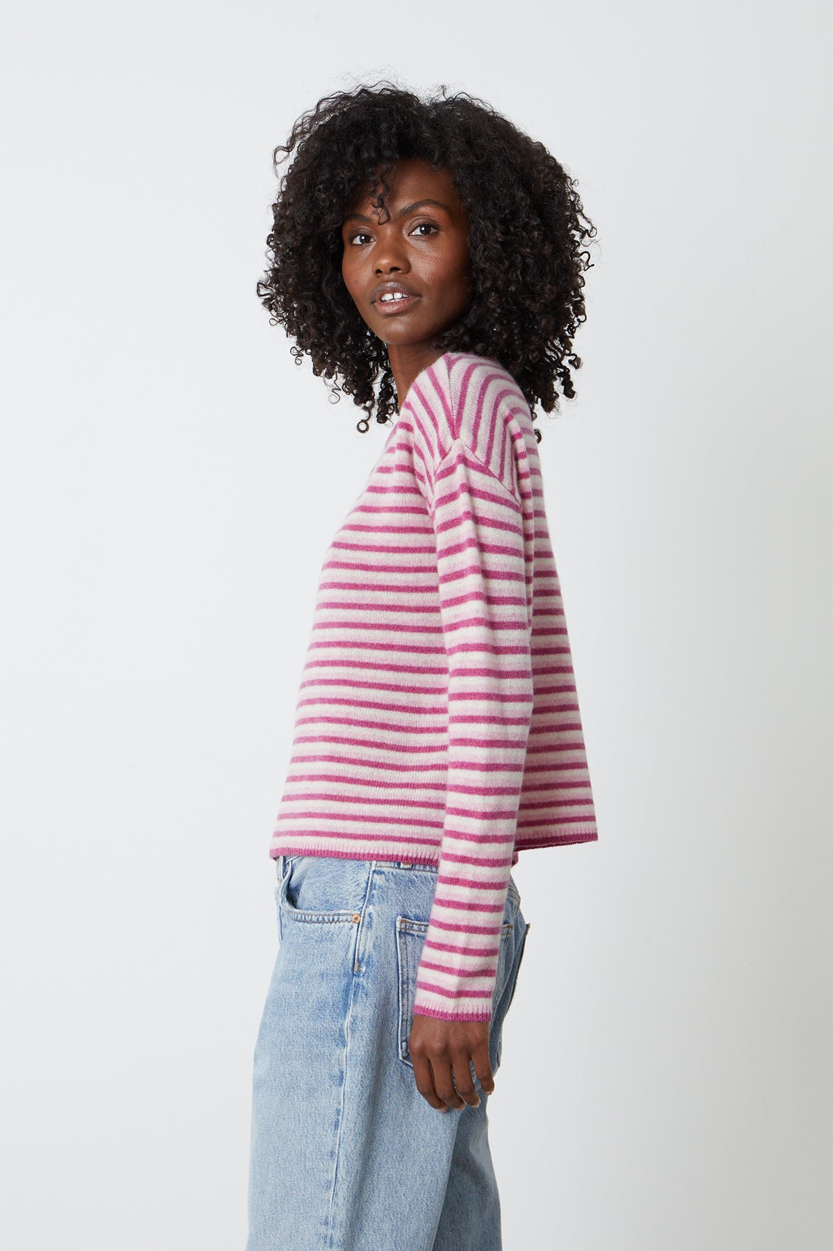   The model is wearing a Velvet by Graham & Spencer CADIE CASHMERE STRIPED SWEATER and jeans. 