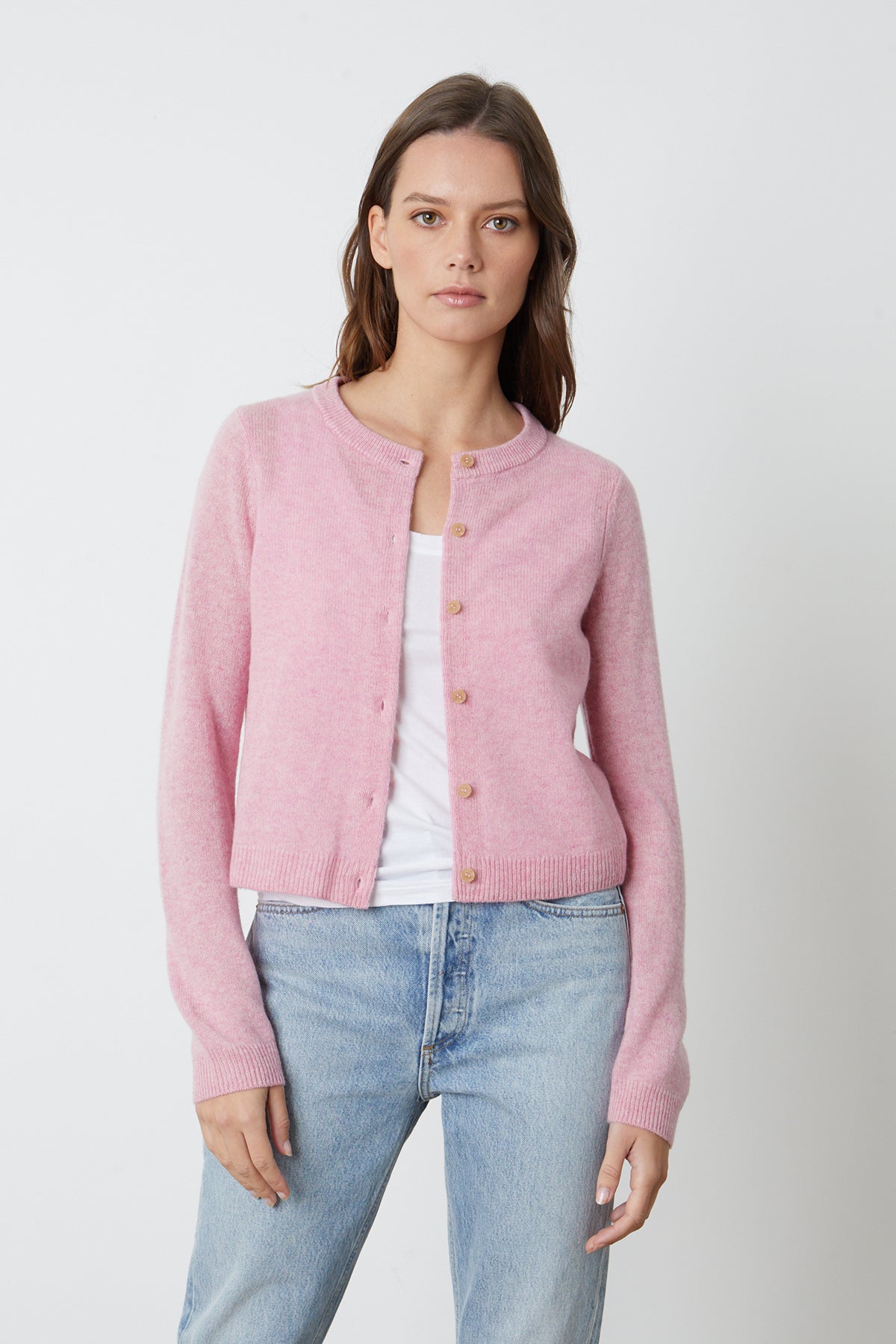 a woman wearing a Velvet by Graham & Spencer pink NANI CASHMERE CARDIGAN and jeans.-25916271689921