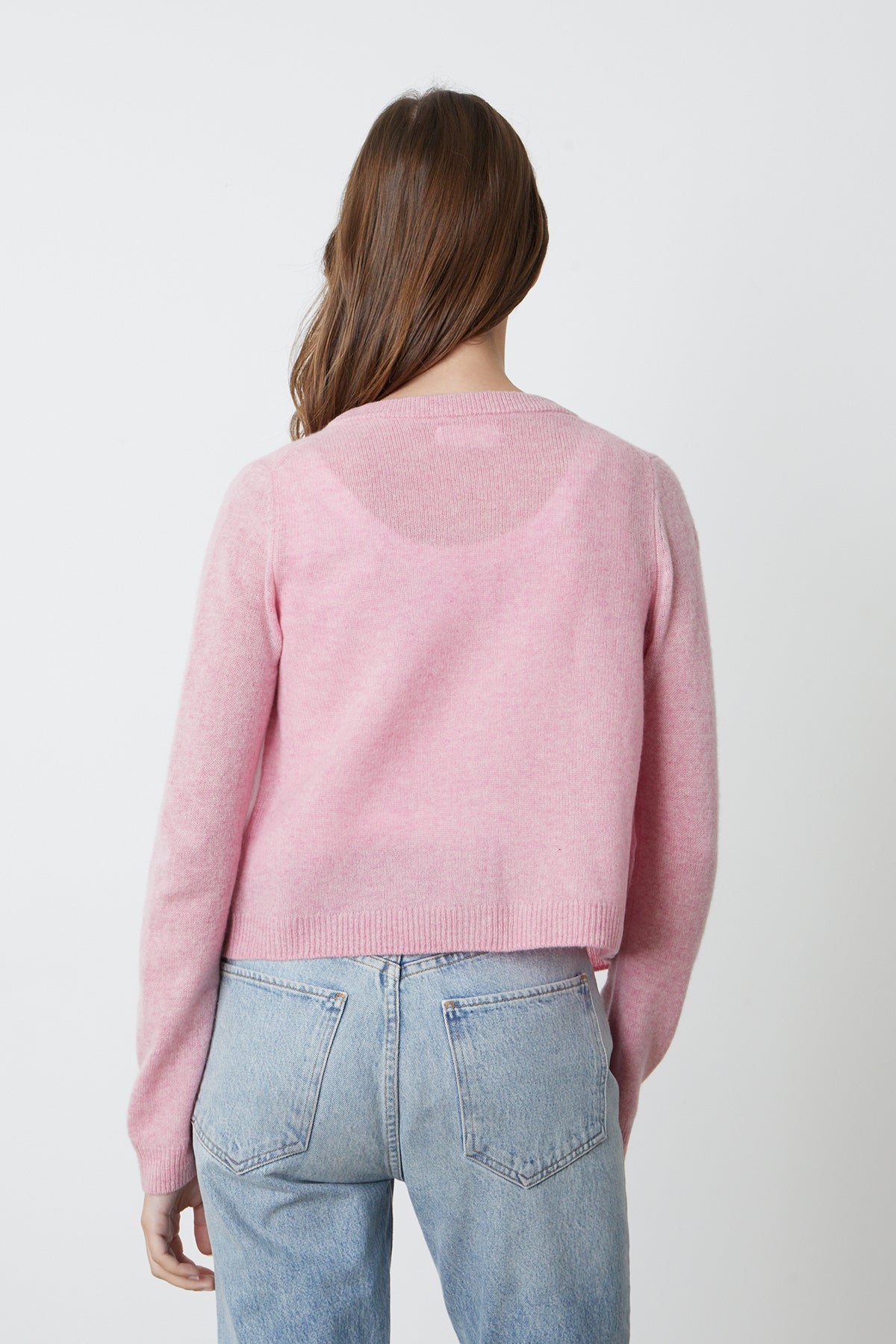   the back view of a woman wearing a NANI CASHMERE CARDIGAN by Velvet by Graham & Spencer and jeans. 