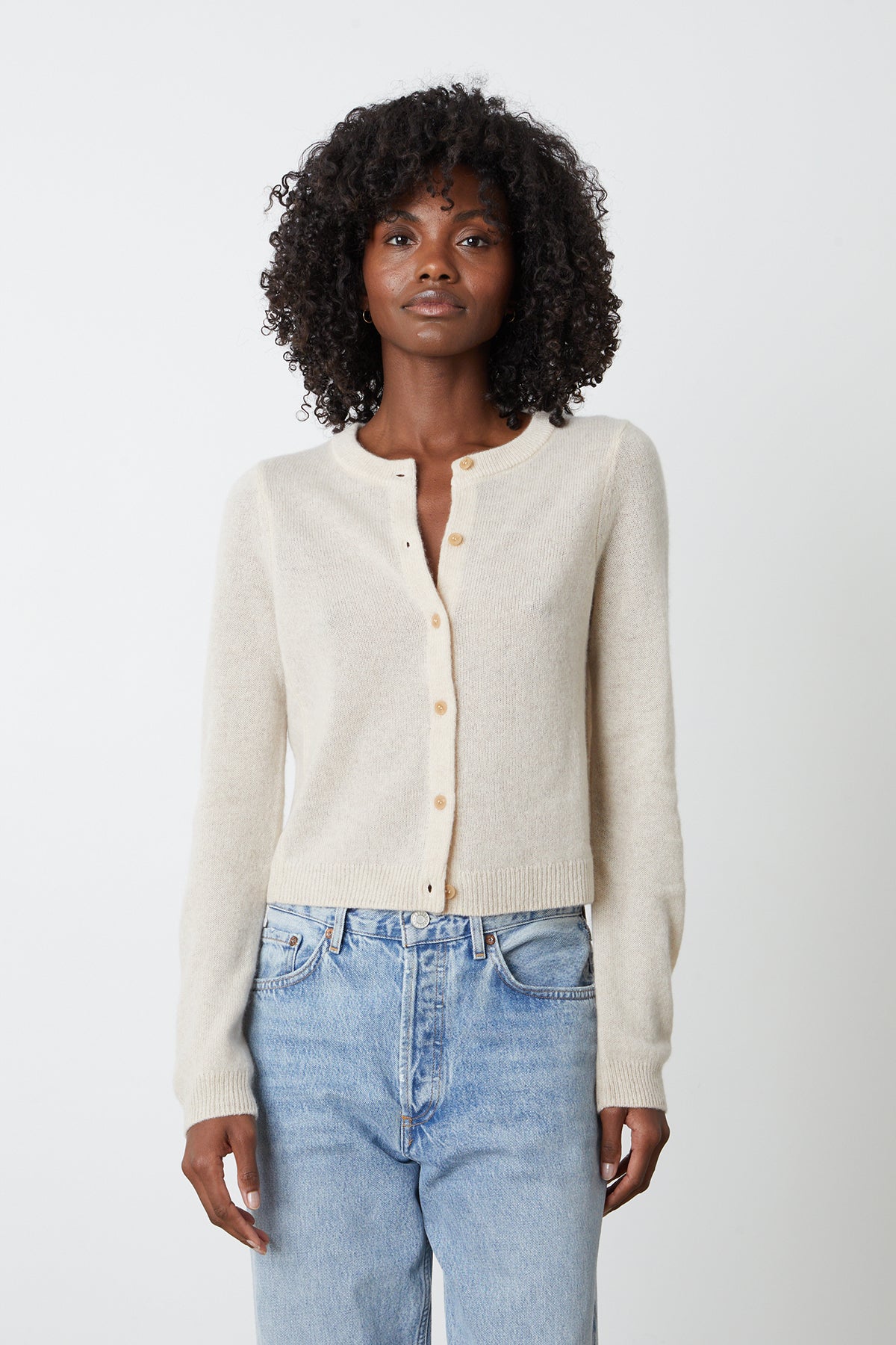   The model is wearing a NANI CASHMERE CARDIGAN by Velvet by Graham & Spencer and jeans. 