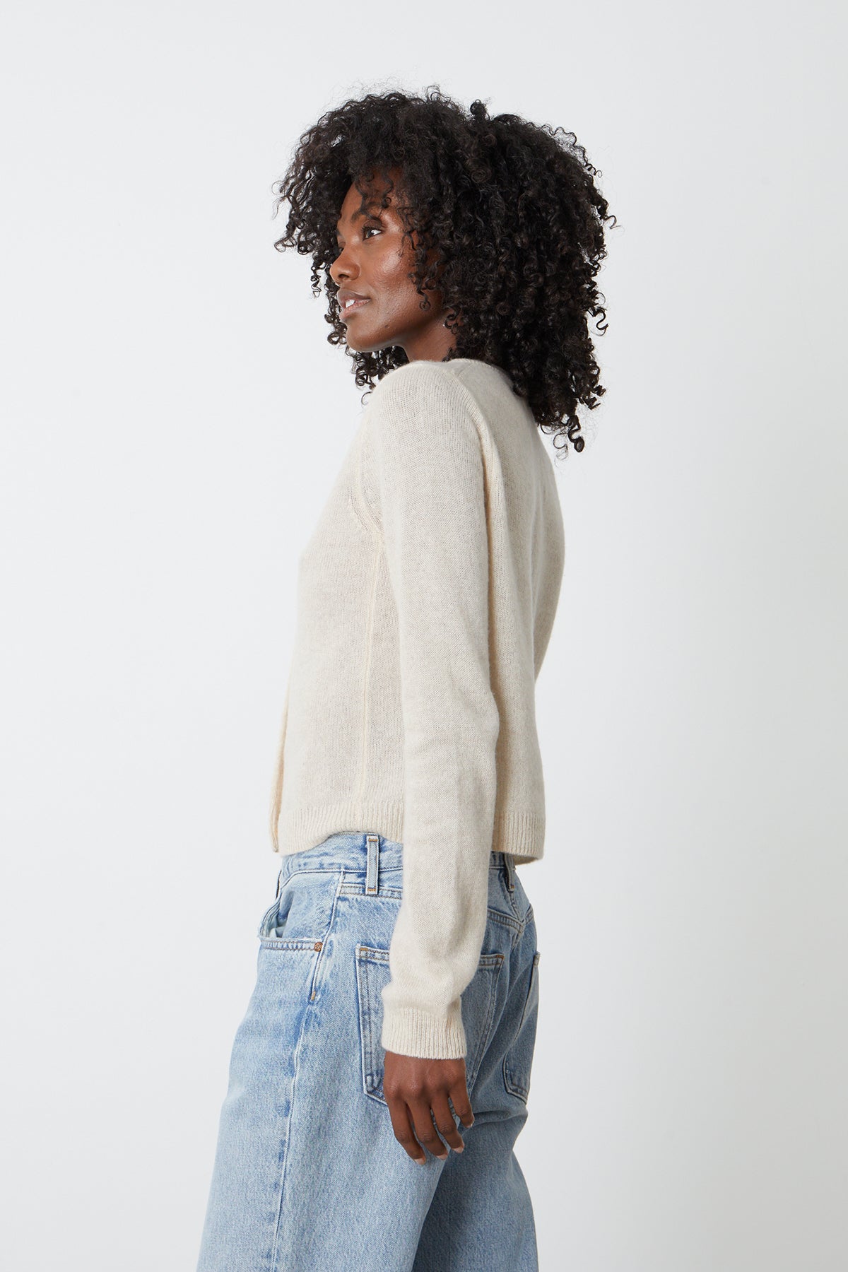 the back view of a woman wearing jeans and a Velvet by Graham & Spencer NANI CASHMERE CARDIGAN sweater.-25916271886529