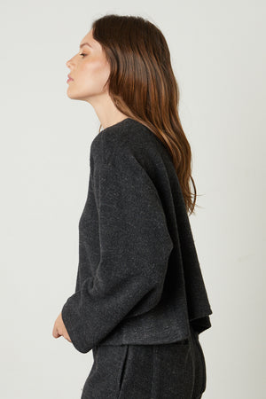 The model is wearing a Grey Velvet by Graham & Spencer Arissa Cropped Sweatshirt and leggings.