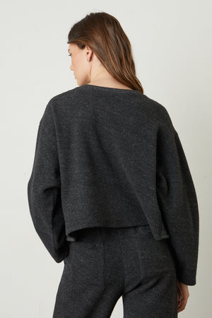 the back view of a woman wearing a Velvet by Graham & Spencer ARISSA CROPPED SWEATSHIRT and pants.
