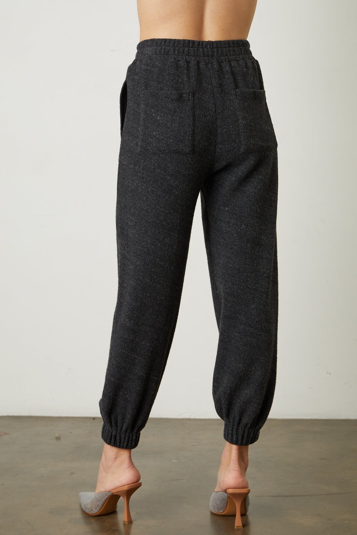the back view of a woman wearing Velvet by Graham & Spencer's BROOKIE FLEECE JOGGER pants.-26068049985729