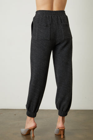the back view of a woman wearing Velvet by Graham & Spencer's BROOKIE FLEECE JOGGER pants.