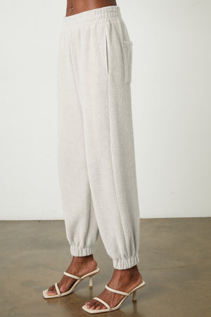 The model is wearing a pair of Velvet by Graham & Spencer BROOKIE FLEECE JOGGER pants.