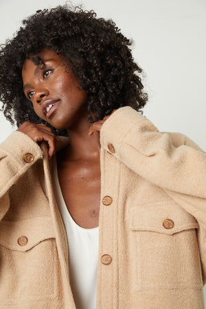 The model is wearing a KAMERON FLEECE SHACKET jacket from Velvet by Graham & Spencer.