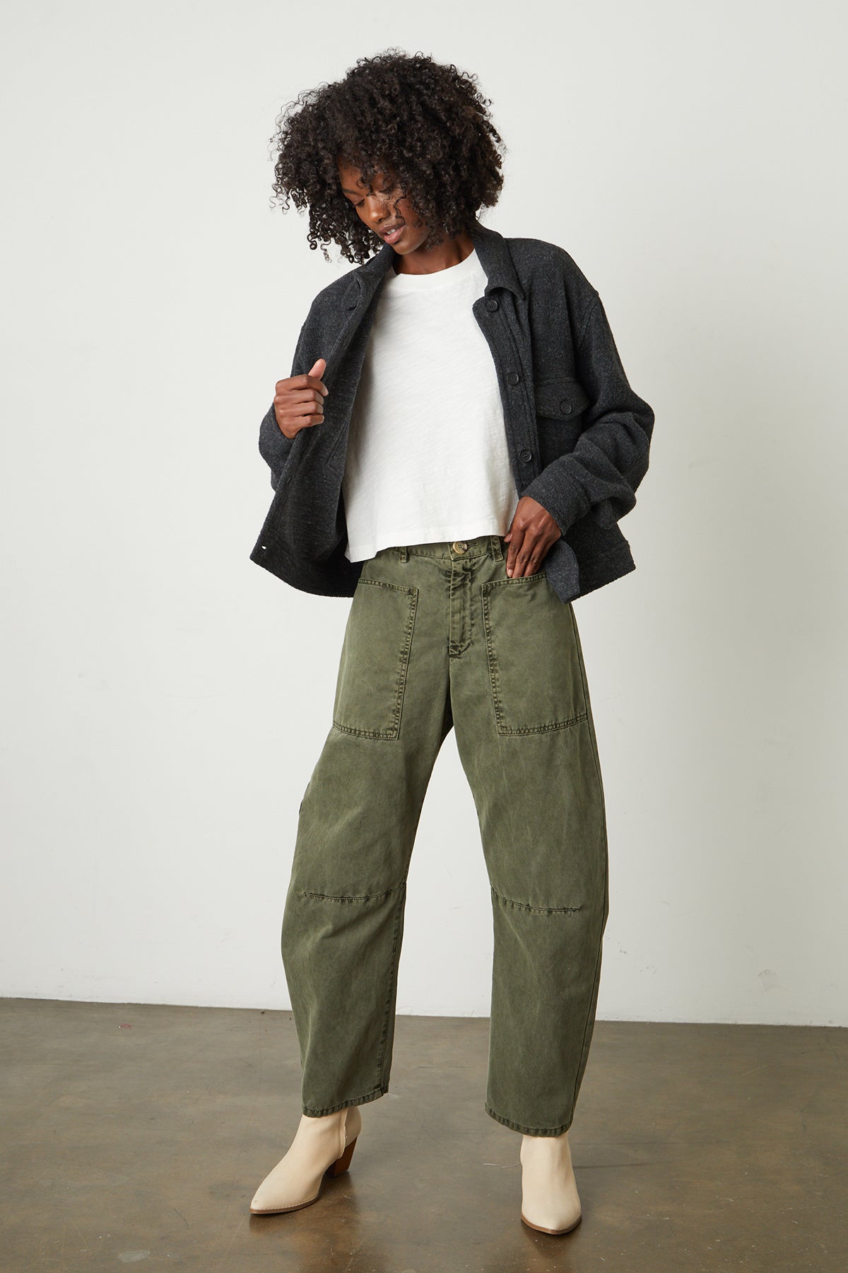   The model is wearing a pair of green cargo pants and a Velvet by Graham & Spencer KAMERON FLEECE SHACKET. 