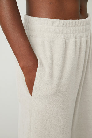 A close up of a woman wearing Velvet by Graham & Spencer BROOKIE FLEECE JOGGER sweatpants.