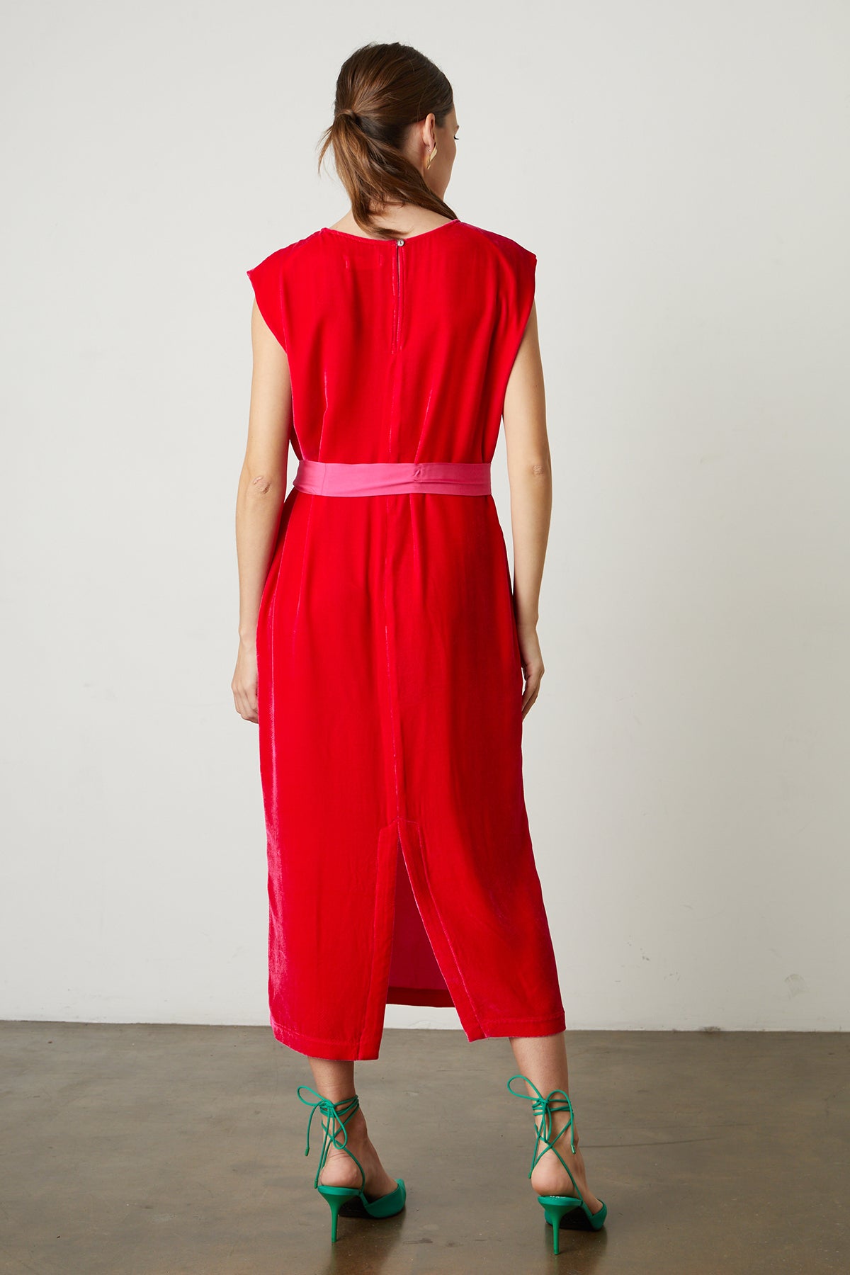 The back view of a woman wearing a KANDACE SILK VELVET MAXI DRESS by Velvet by Graham & Spencer.-25548533039297