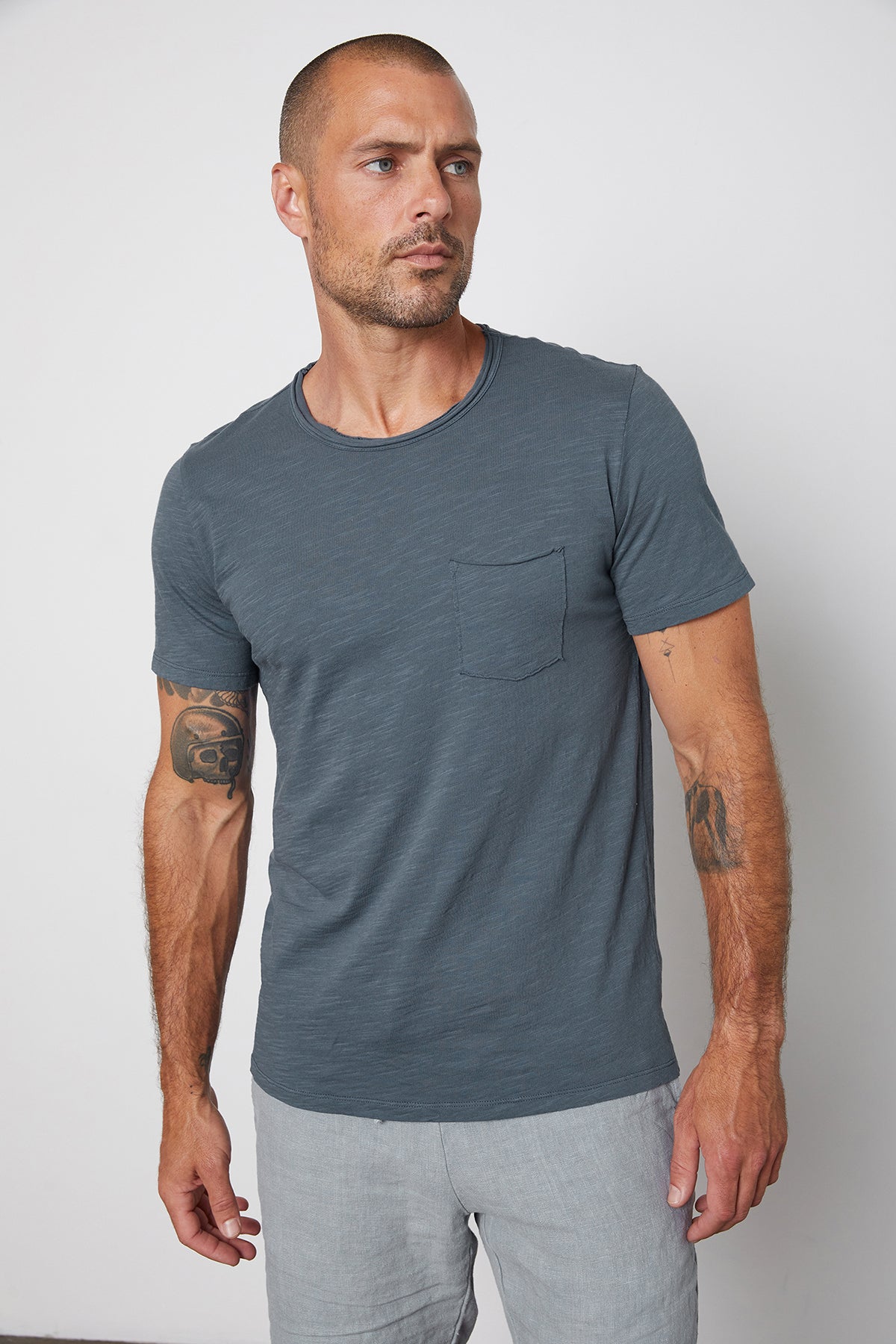 Chad slub cotton tee with raw edges and front pocket in malachite, with Jonathan shorts in chambray.-25328431530177