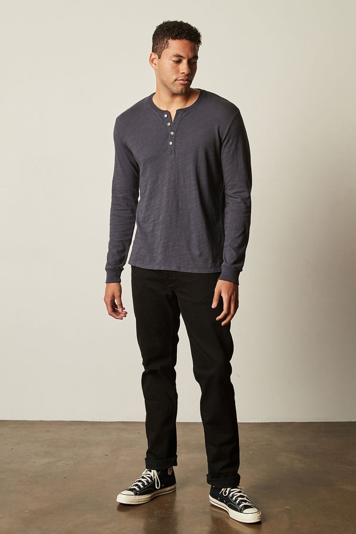   Gabe Henley in ink with black denim full length front with black Converse 