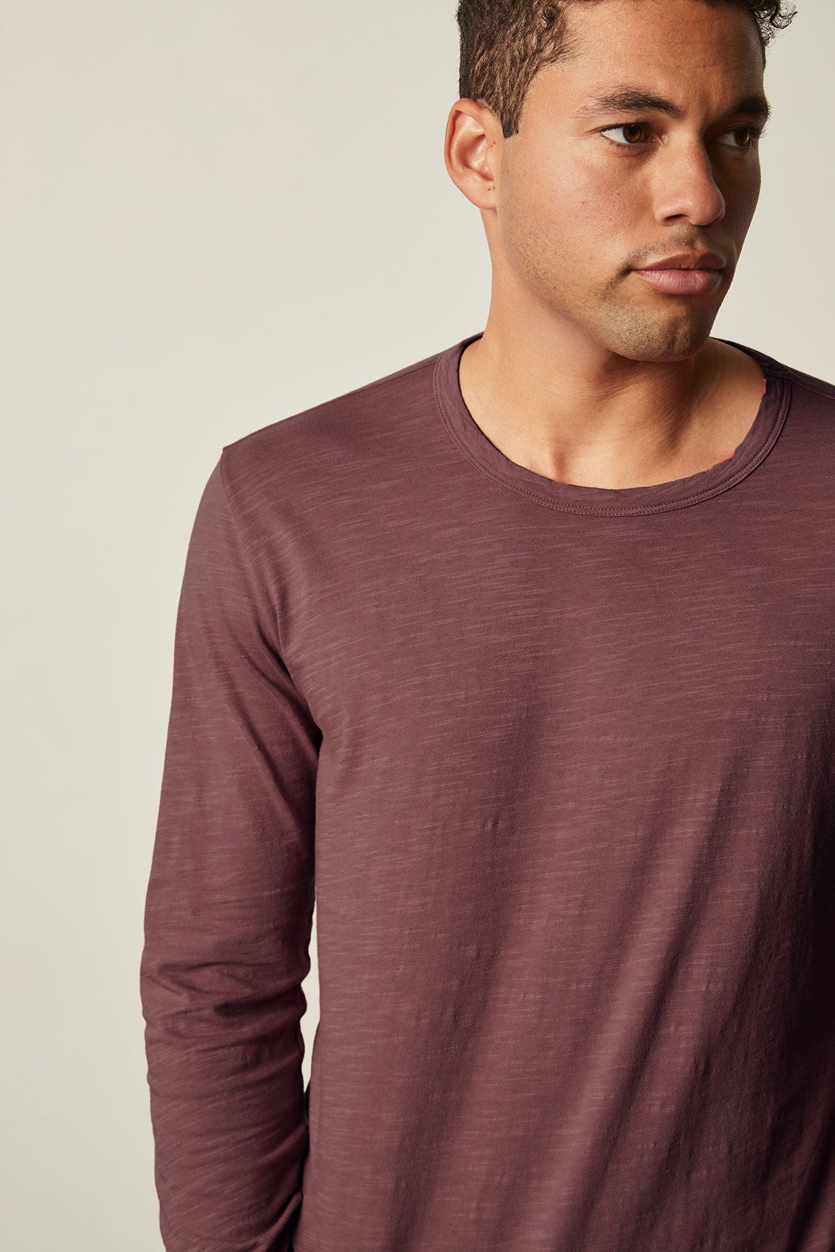   A man sporting a KAI CREW NECK TEE by Velvet by Graham & Spencer, perfect as a layering piece or worn on its own. 