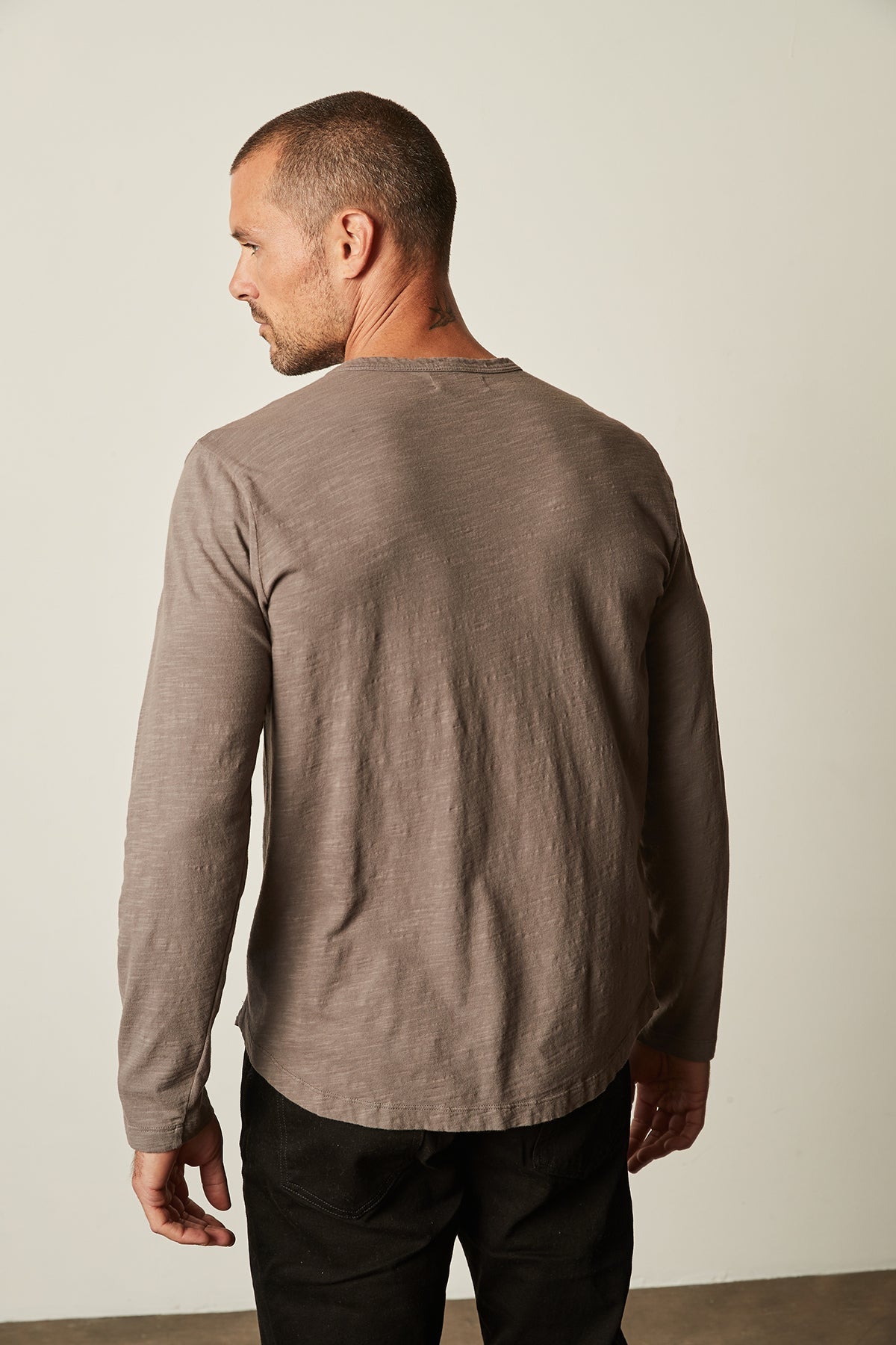   The back view of a man wearing a Velvet by Graham & Spencer KAI CREW NECK TEE, perfect as a layering piece. 