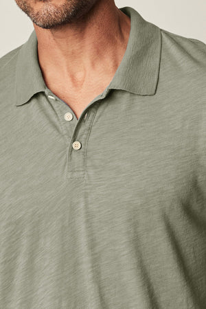 A man wearing a NIKO POLO shirt by Velvet by Graham & Spencer.