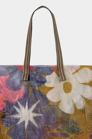 Striped handle detail on small mesh tote with olive background and large multi colored flowers.