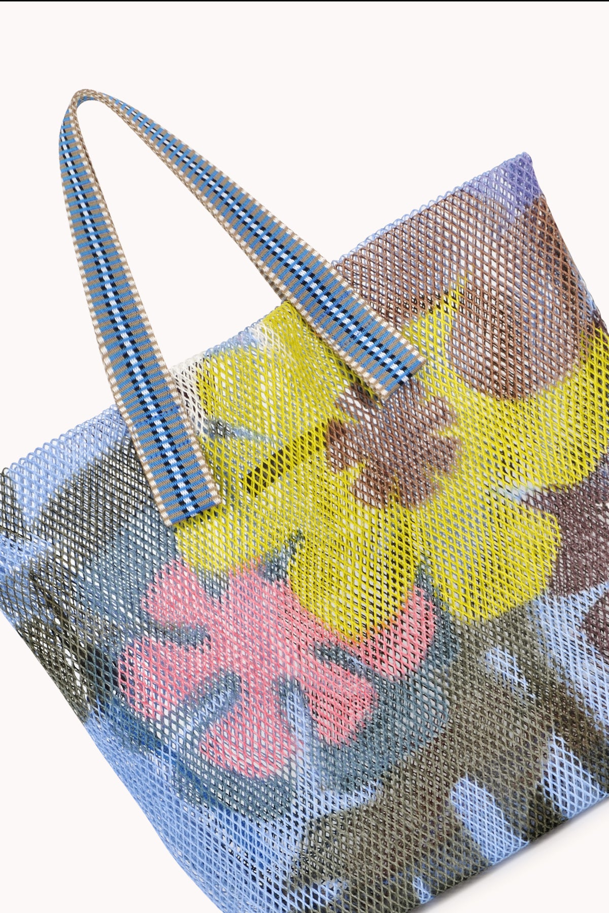  Small mesh tote in blue with multi colored flowers and striped strap. 