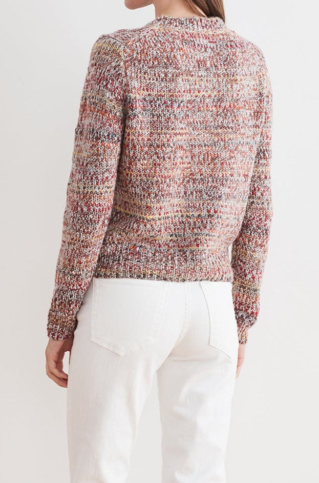   A person wearing the ALEXIS MARLED CARDIGAN from Velvet by Graham & Spencer and white pants is shown from the back against a light background. 