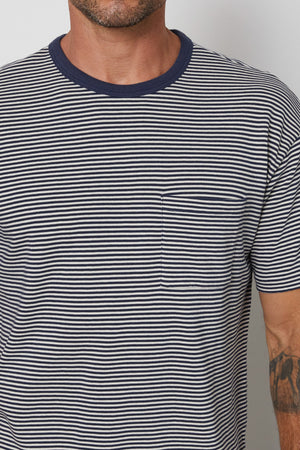 Patch pocket detail on Eli striped crew neck tee with navy contrast rib band around neckline.