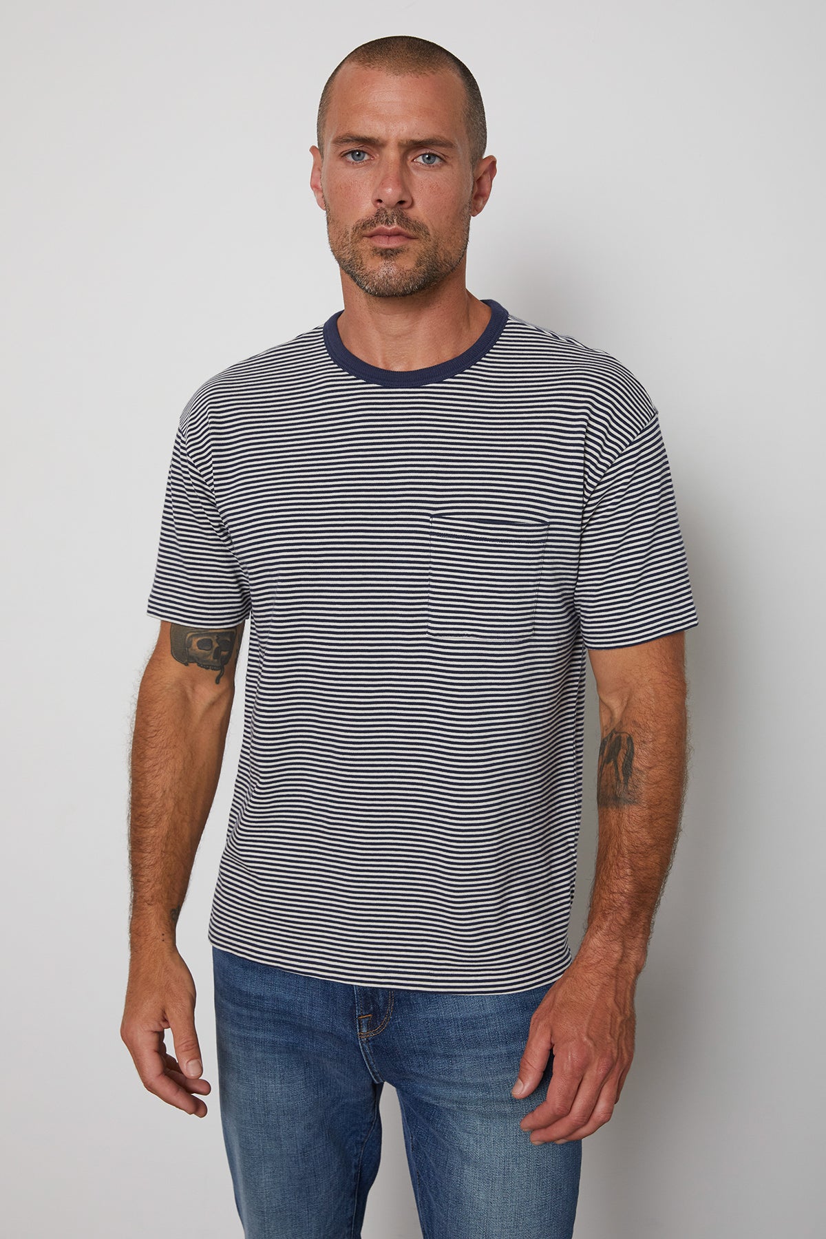   Eli striped crew neck tee with front patch pocket and  navy contrast rib band around neckline. 