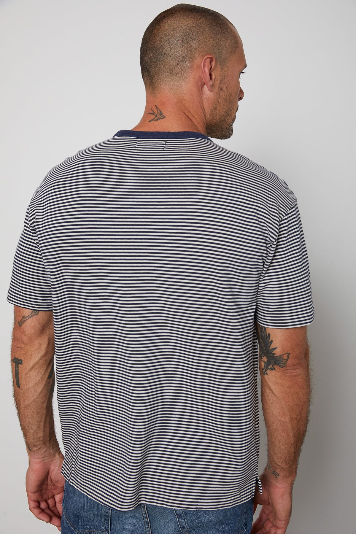   Eli striped crew neck tee with front patch pocket and  navy contrast rib band around neckline back 