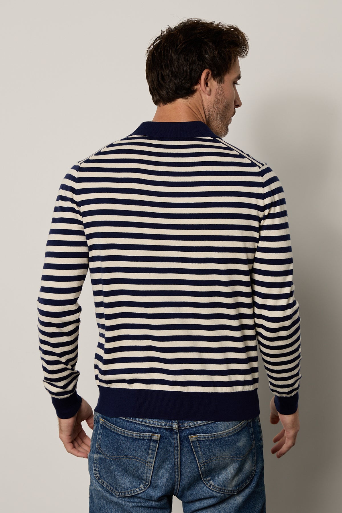 The back view of a man wearing a Velvet by Graham & Spencer RICKY STRIPED POLO sweater.-25943739924673
